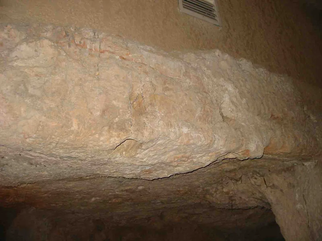 Holes in stone for chains in the prison at Gallicantu