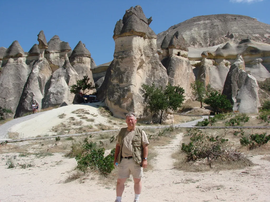Dr. House in Front of Cone Shaped Structures in Cappadocia, Used as Homes and Churches