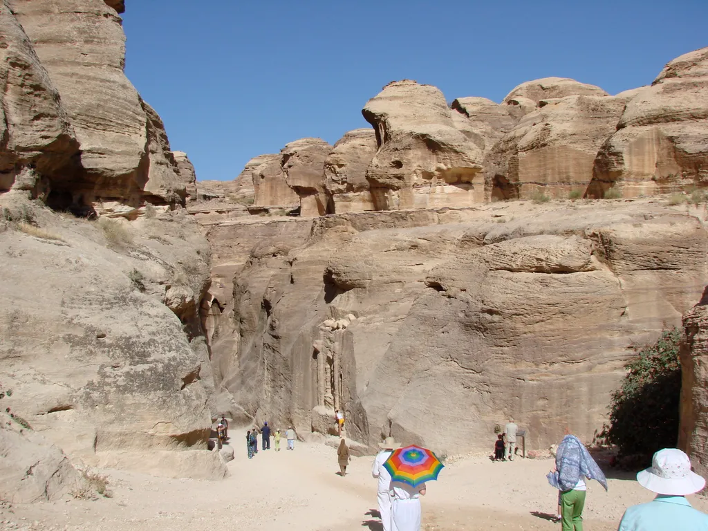 Entrance to the sites of Petra, leading through Siq to the Exit of the Siq and the Tomb in front of the exit.